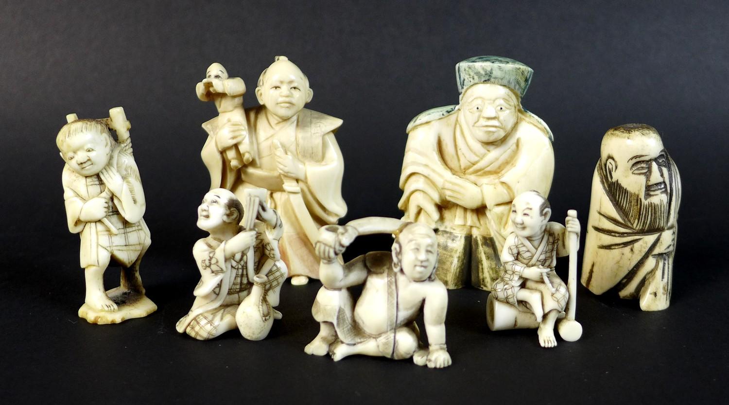 A group of Japanese Meiji period ivory figures comprising three netsuke, one of a gentleman with a