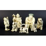 A group of Japanese Meiji period ivory figures comprising three netsuke, one of a gentleman with a