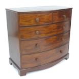 A Regency mahogany bowfront chest of drawers, two short over three long, with cock beading and