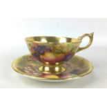 A mid 20th century hand painted Aynsley tea cup and saucer, signed by Doris Jones, in Orchard Gold
