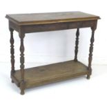 An 18th century style oak side table, with carved freeze decorated with shells, turned legs and