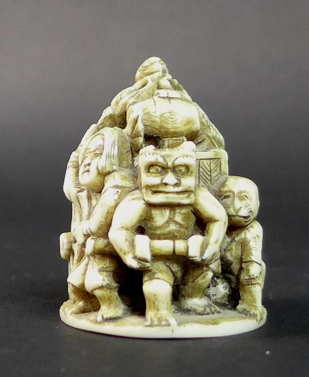 A Meiji period ivory netsuke, formed as a cart being pulled by a demon, with three further - Image 2 of 11