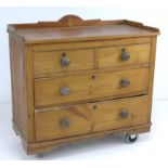 An Edwardian pine chest of four drawers, three quarter upstand, turned handles, raised on modern
