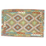 A vegetable dyed wool Choli Kilim rug, with diamond patterned field separated by white latch hook