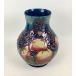 A Moorcroft pottery finch and berry pattern baluster form vase, with impressed marks to base, signed