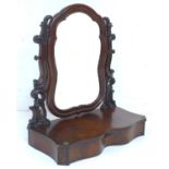 A Victorian mahogany toilet mirror, with scroll frame, serpentine front housing a single drawer with