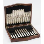 A set of twelve silver and mother-of-pearl dessert or fruit knives and forks,
