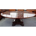 A modern mahogany extending 'Jupe style' dining table, the circular top 150cm diameter,