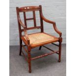 A late 19th century Arts and Crafts beech and walnut square back open armchair, on turned supports,