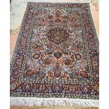 An Indian part silk rug, the ivory field with a black floral medallion, all with animals, birds,