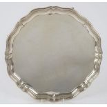 A silver salver, of shaped circular form, in the Chippendale style,