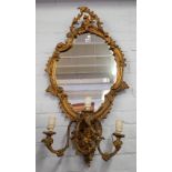 A 19th century gilt framed girandole wall mirror with asymmetric opposing 'C' scroll frame over