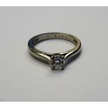 A platinum and diamond single stone ring, claw set with a circular cut diamond, ring size M,