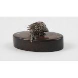 A Patrick Mavros place name or menu stand, modelled as a porcupine on an oval wooden stand,