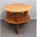 A 20th century circular laminated oak and beech two tier circular table, 64cm diameter x 51cm high.