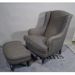 A mid-20th century hardwood framed wingback armchair,