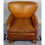 An early 20th century framed hardwood armchair with tan leather upholstery, 63cm wide x 70cm high.