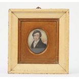 A miniature on ivory, 19th century depicting a gentleman in a black coat, framed and glazed,