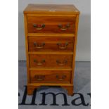 A 20th century yew wood chest of four short drawers on bracket feet, 41cm wide x 79cm high.