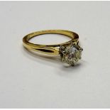 A gold and diamond single stone ring, claw set with a circular cut diamond, detailed 14 K,