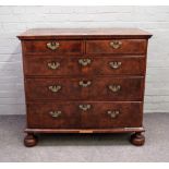 A mid-18th century figured walnut chest of two short and three long graduated drawers, on bun feet,