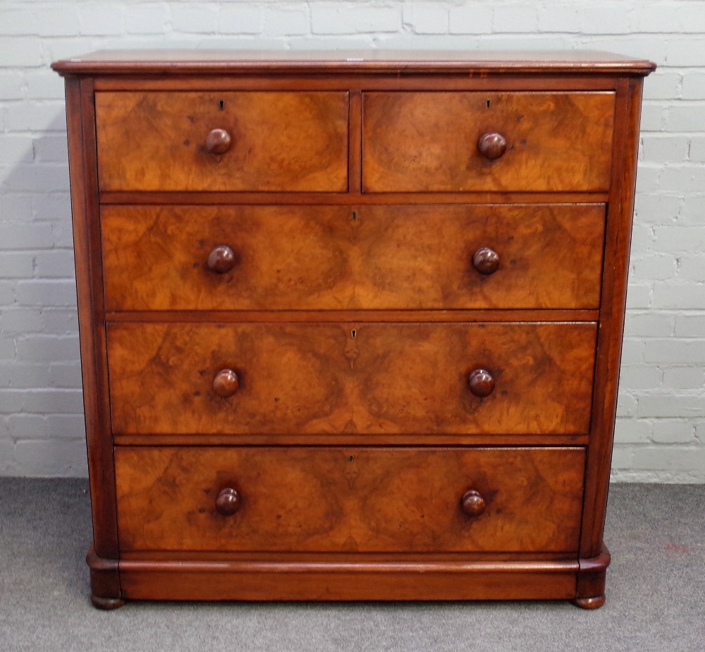 A Victorian figured walnut chest of two short and three long graduated drawers, on plinth base,