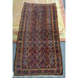 An Afghan Beluche rug, the field with an allover design of columns of flowering plants,