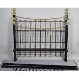 A Victorian style black painted metal and brass double bed, 152cm wide x 155cm high.