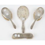 A silver mounted four piece part dressing set, comprising; a hand mirror,