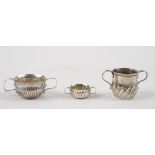 A silver twin handled miniature porringer, with semi-fluted decoration,