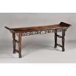 A late 19th century Chinese hardwood altar table, the rectangular top with upswept ends,