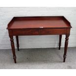 An early 19th century mahogany two drawer writing desk on turned supports, 108cm wide x 80cm high.