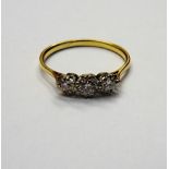 A gold and diamond set three stone ring,