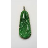 A silver mounted jade drop shaped pendant, with carved and pierced decoration, designed as fruit.