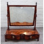 A Regency mahogany toilet mirror with serpentine two drawer base on turned supports,