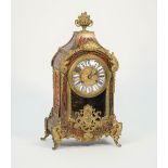 A french Boulle work mantel clock, late 19th century, with foliate finial, enamel numerals,