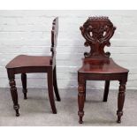 A pair of early Victorian mahogany hall chairs,