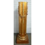 A 20th century gold painted column, the fluted body with ribbon tied floral swag, on a square base,