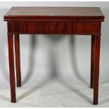 A George III mahogany foldover card table on square supports, 74cm wide x 73cm high.