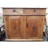 A 17th century and later Italian walnut commode with a pair of drawers over pair of cupboards,