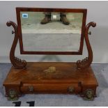 An Empire mahogany swing frame toilet mirror with cushion drawer base and gilt metal lions mask