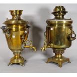 A Russian brass samovar with twin handles and tap, 51cm high and another similar brass samovar, (2).