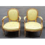 A pair of George III gilt framed open armchairs,