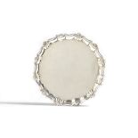 A George II silver salver, of shaped circular form, decorated with a shell and pie-crust rim,