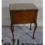 An Edwardian walnut lift top side table with single side drawer on cabriole supports,
