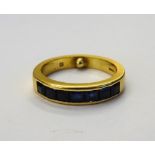 An 18ct gold and sapphire half hoop ring,