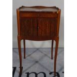 A 19th century Continental walnut and mahogany bedside table with single drawer over cupboard on