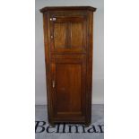 An 18th century style oak floor standing corner cabinet with panelled doors, 74cm wide x 166cm high.