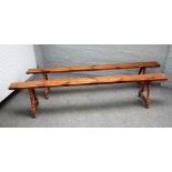 A pair of 19th century French fruitwood benches on turned supports, 227cm wide x 45cm high.