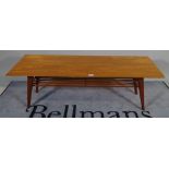 A 20th century teak rectangular coffee table on tapering supports, 138cm wide x 45cm high.